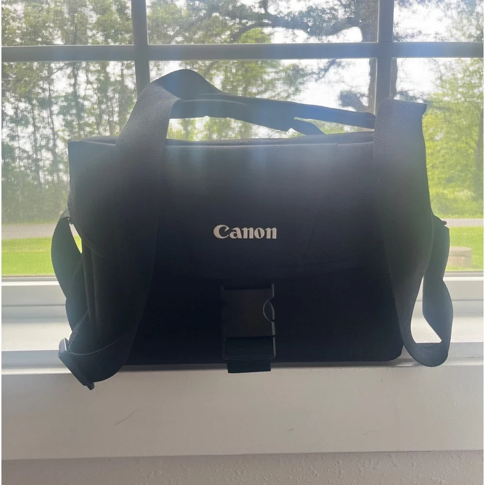 Canon T-5 Camera + Lense + Travel Bag. Had for a few years and never used!